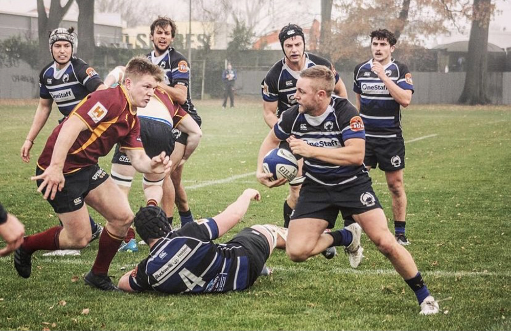 Seamus playing in a rugby match nwith other rugby players