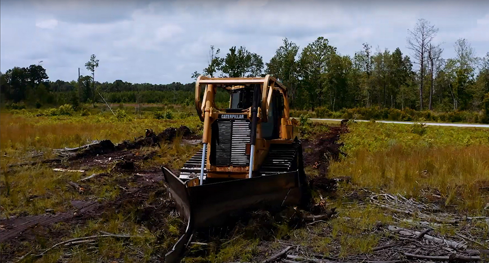 V Plow pushing debris away