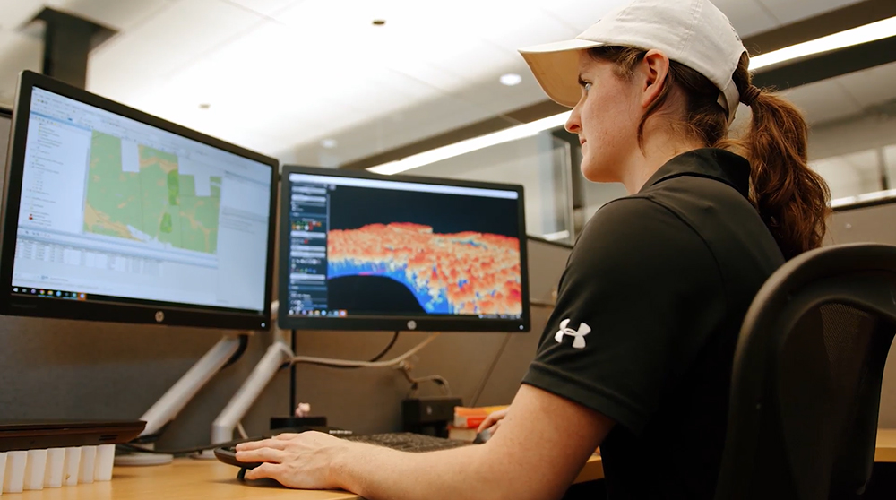 Stephanie views computer screens at her desk