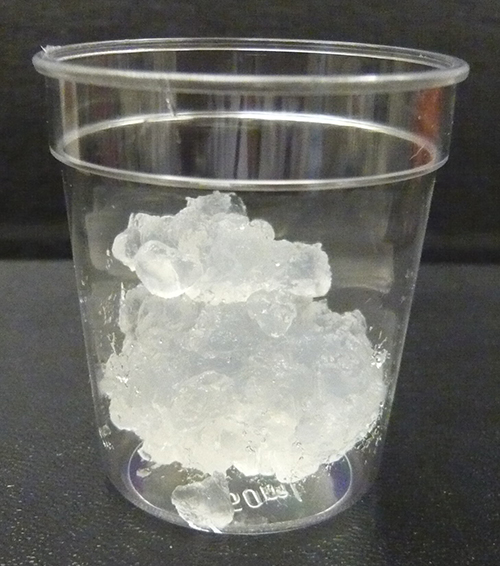 clumps of transparent nanocellulose in a plastic cup