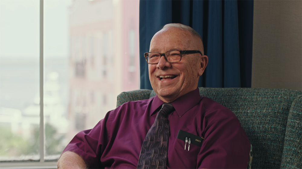 Ed Barnard smiling while sitting in a chair